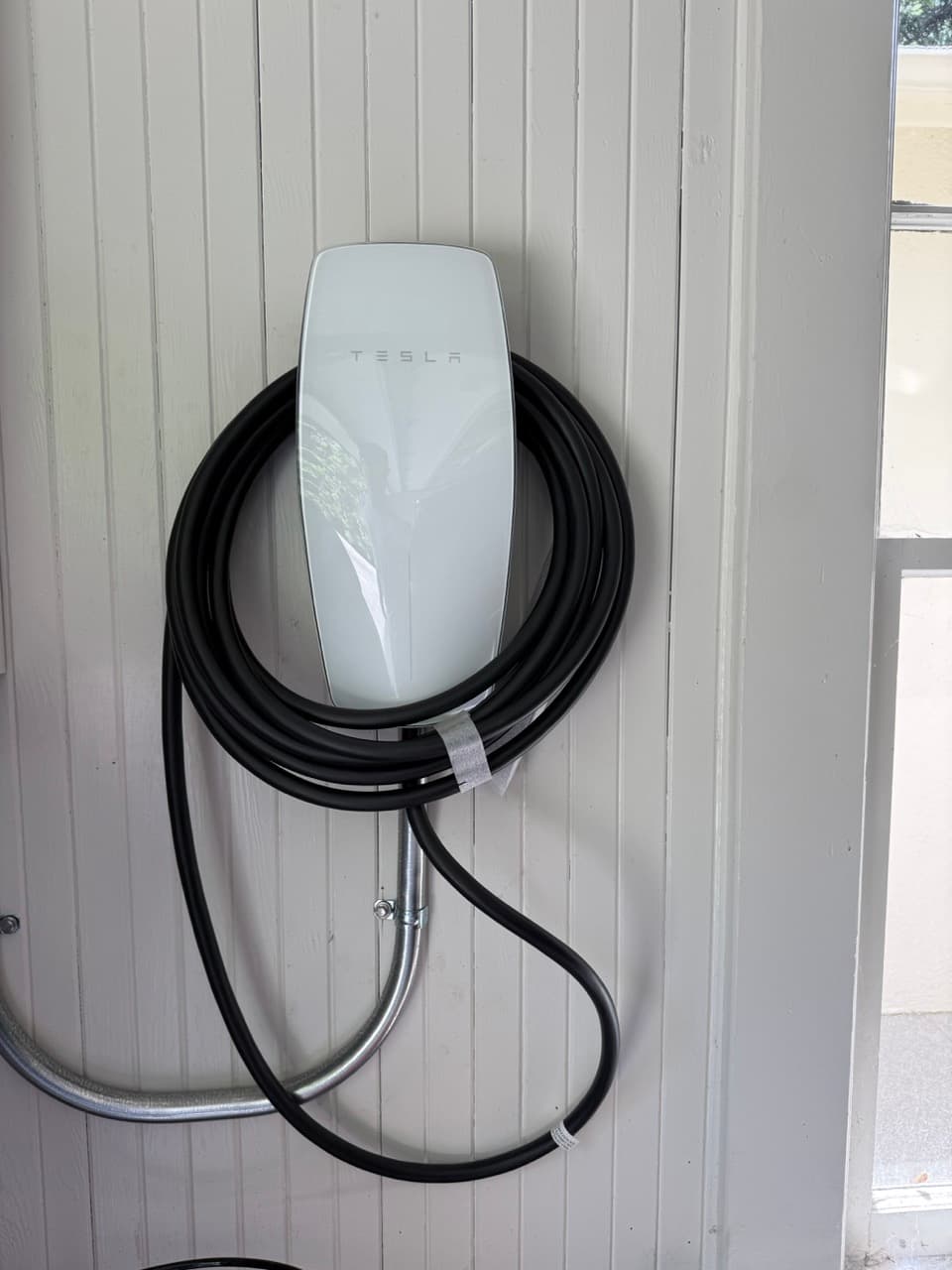 Completed EV charger installation, exterior wall mount.